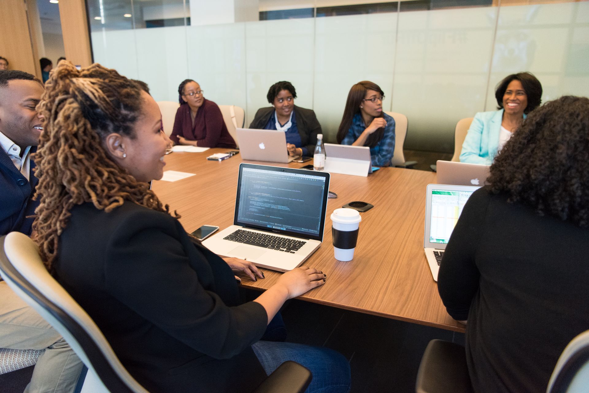 Business team collaborating around laptops in a modern office