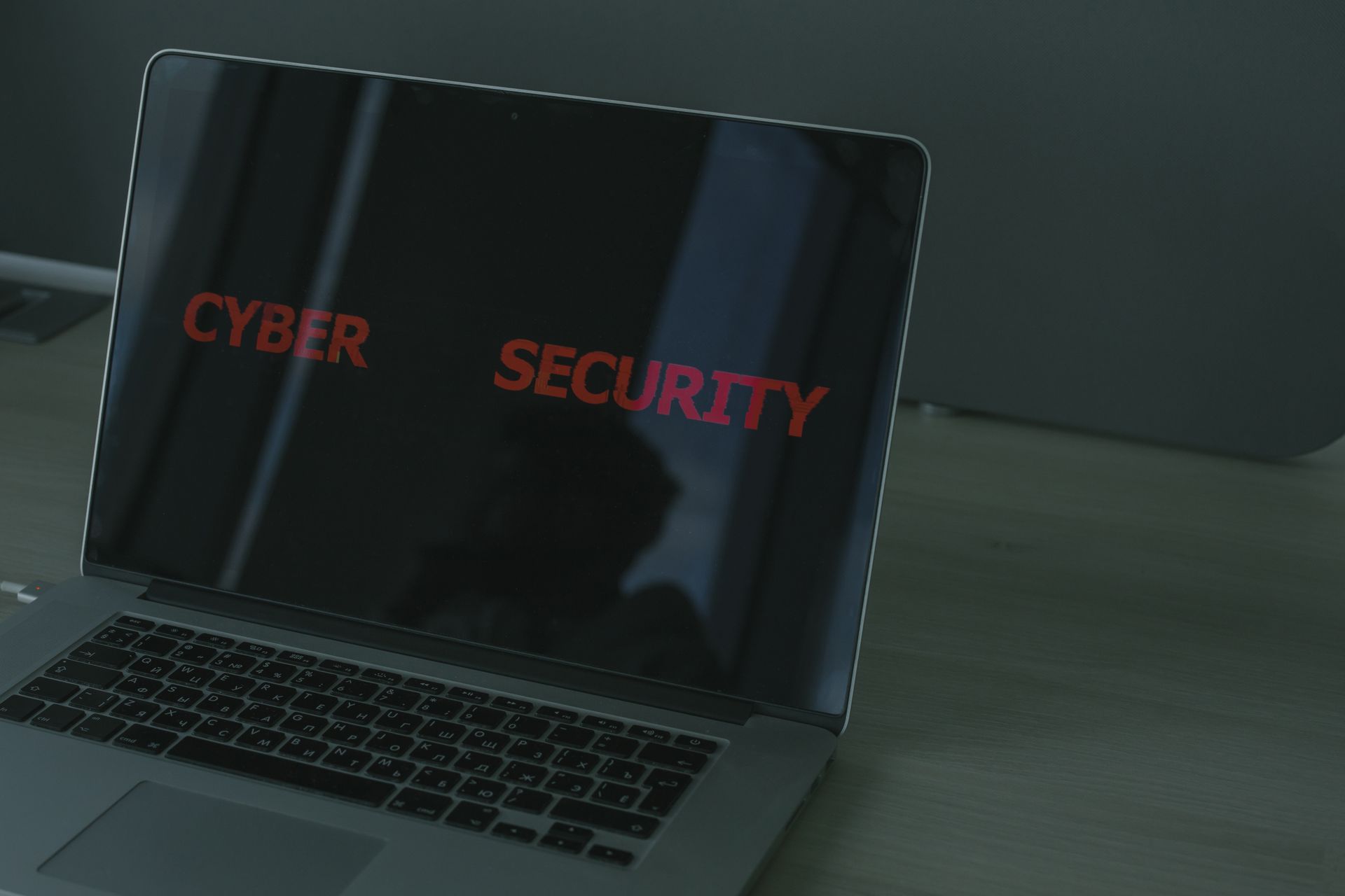 Laptop screen showing cyber security warnings and protection text
