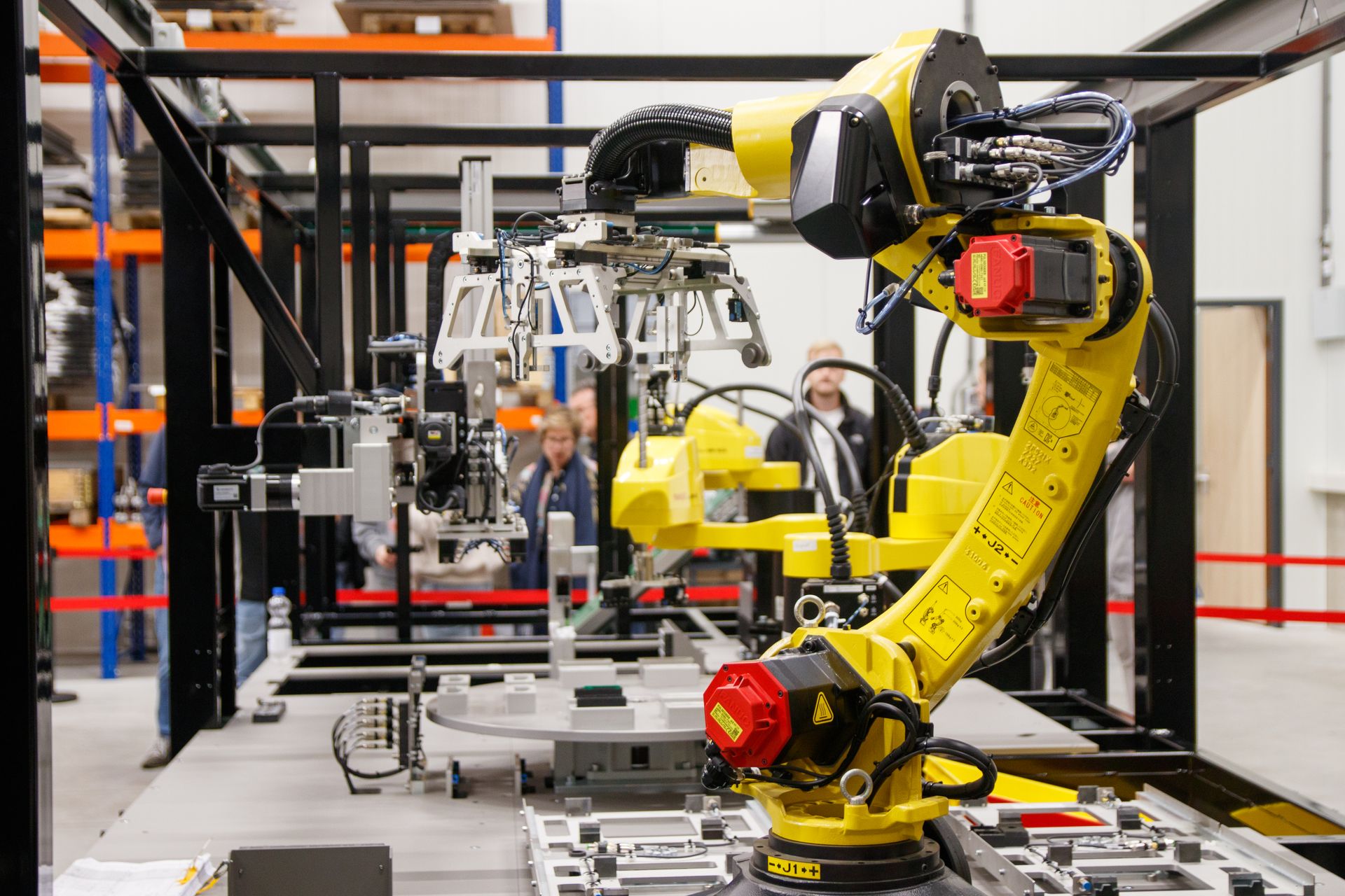 Yellow industrial robot arm on a production line