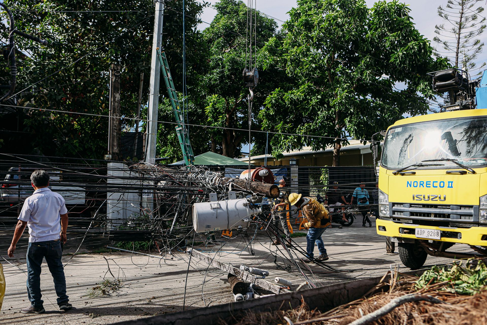 Utility workers repairing power lines outdoors