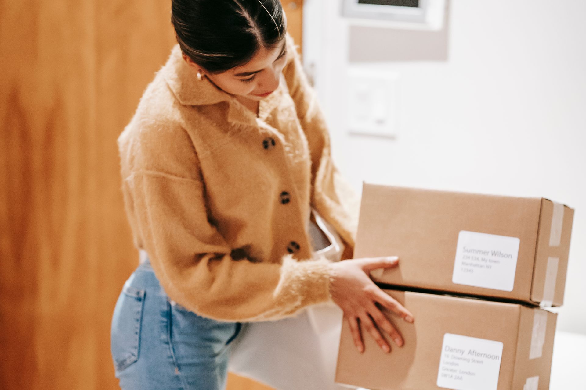 Woman at home surrounded by delivered shopping packages