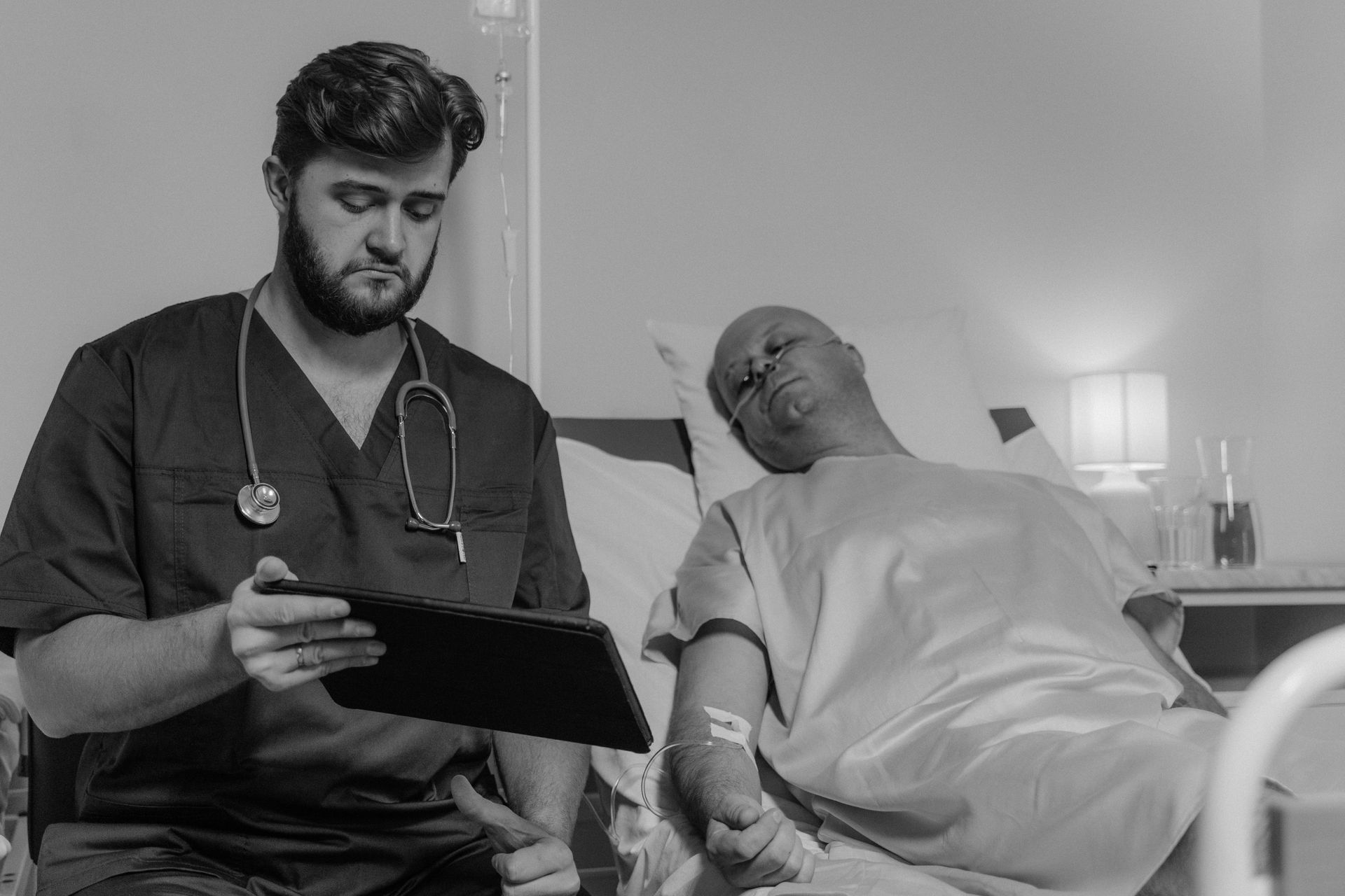 Doctor reviewing a patient's records on a tablet in a hospital room