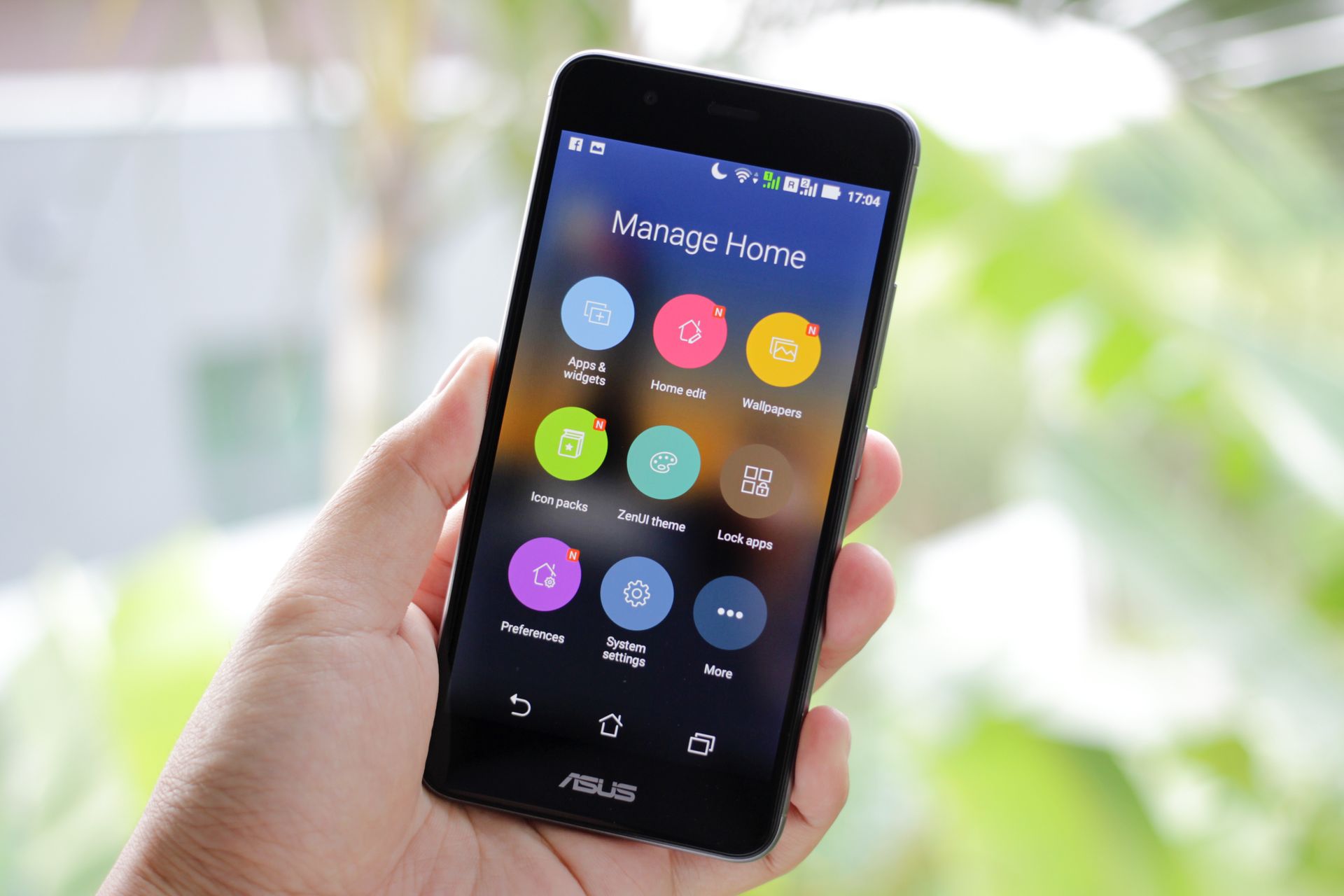 Hand holding a smartphone displaying app icons