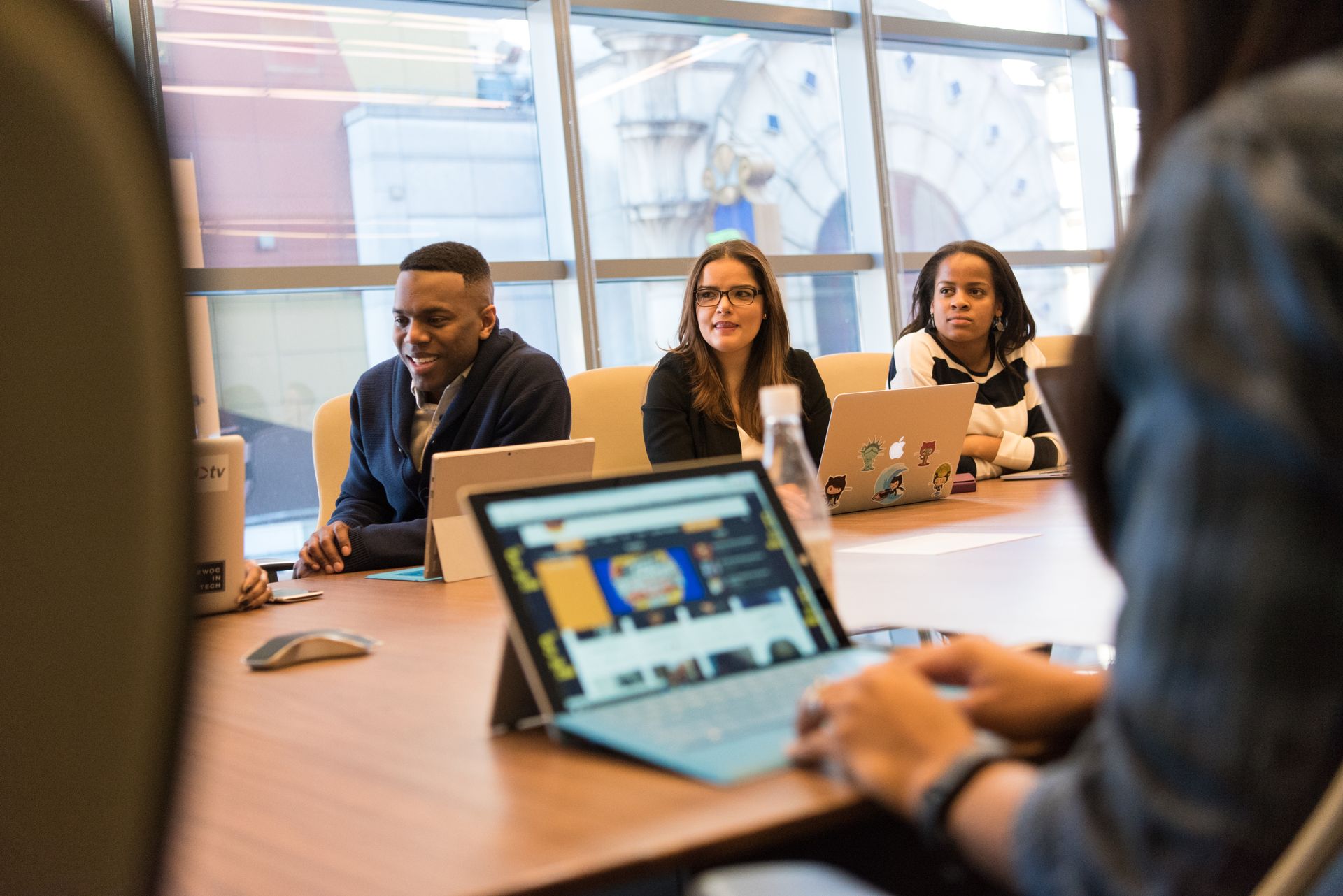 Small team working together on laptops around a table