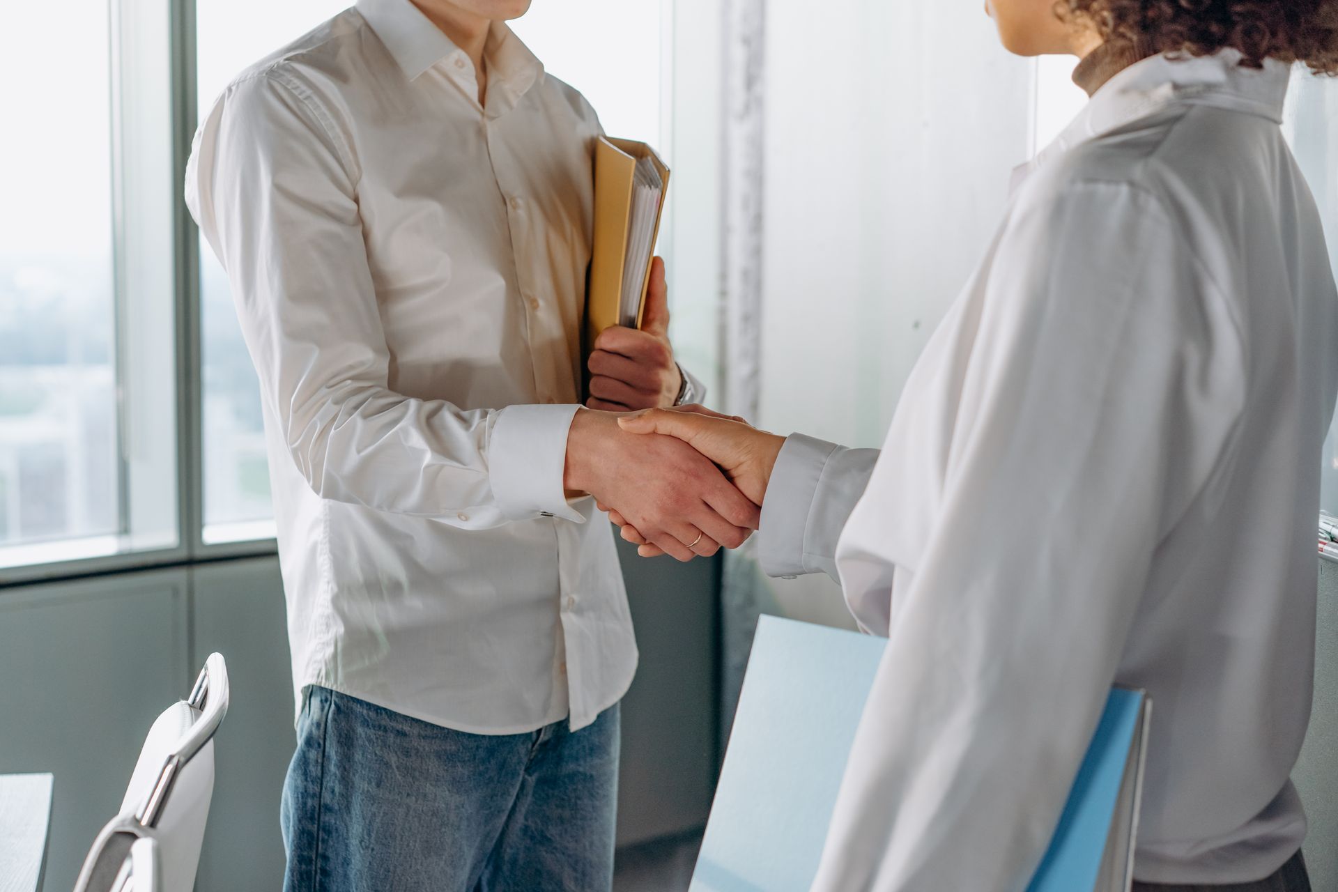Two business professionals shaking hands on a partnership