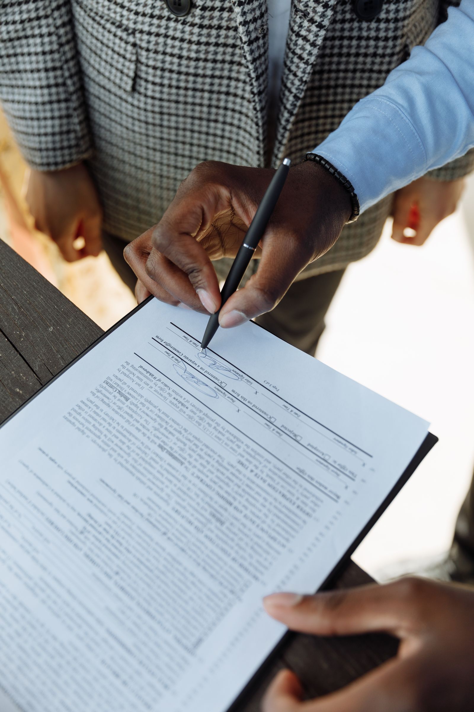 Hand signing a formal document with a pen