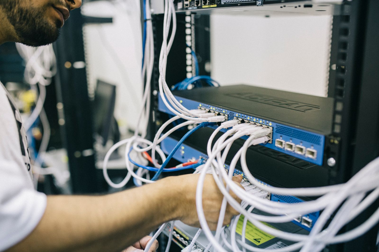 IT professional configuring network cables in a server rack