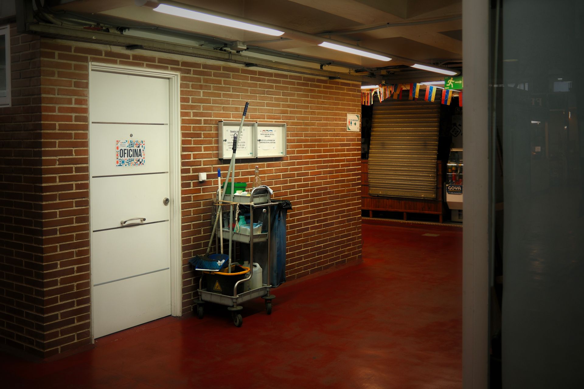Cleaning cart stationed in a bright facility hallway